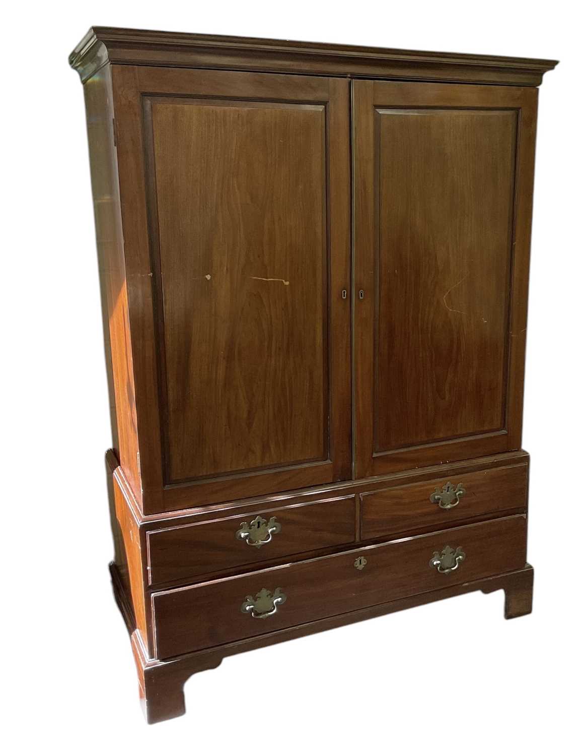 Lot 29 - An early 19th century mahogany linen press,...