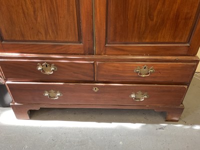 Lot 29 - An early 19th century mahogany linen press,...