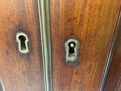 Lot 29 - An early 19th century mahogany linen press,...