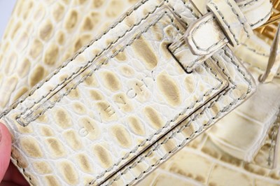 Lot 596 - GIVENCHY; a cream and beige crocodile embossed...