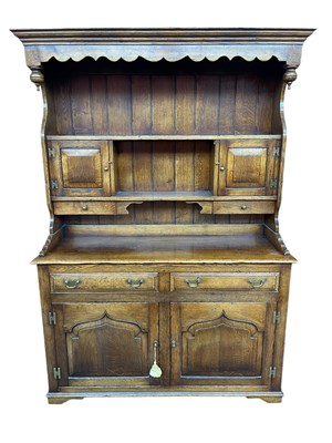Lot 1103 - A reproduction oak dresser, the boarded plate...