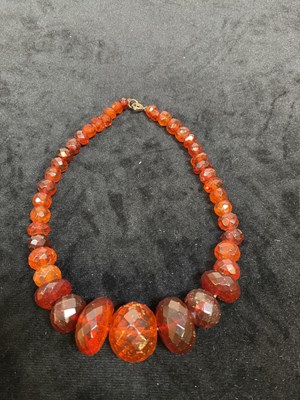 Lot 334 - Two graduated Baltic amber bead necklaces,...