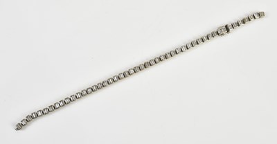 Lot 202 - A white metal diamond set tennis bracelet,...