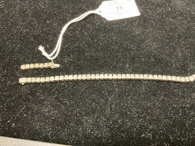 Lot 15 - A white metal diamond set tennis bracelet,...