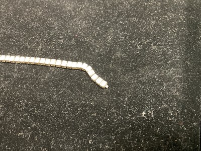 Lot 15 - A white metal diamond set tennis bracelet,...