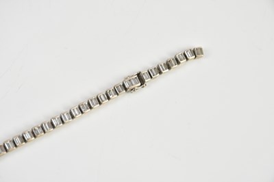 Lot 15 - A white metal diamond set tennis bracelet,...