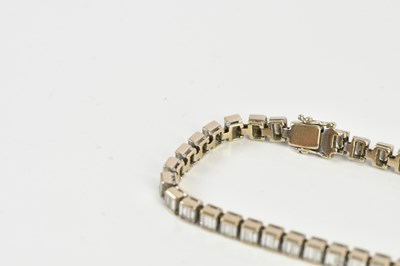 Lot 15 - A white metal diamond set tennis bracelet,...