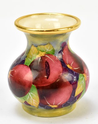 Lot 126 - MOORCROFT; a small enamel vase decorated with pomegranate