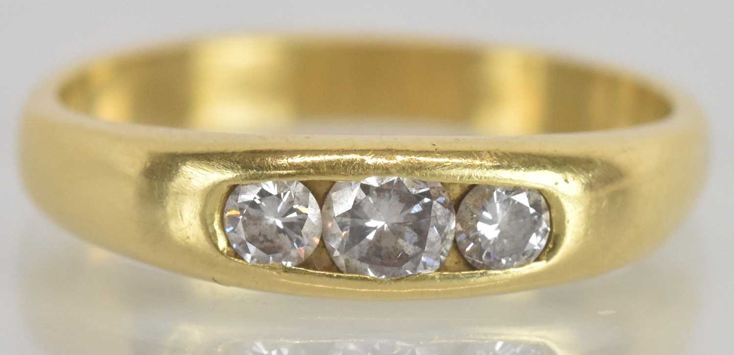 Lot 1278 - A 9ct yellow gold diamond set three stone ring,...