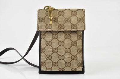Lot 655 - GUCCI; a tan brown cloth monogram and dark...