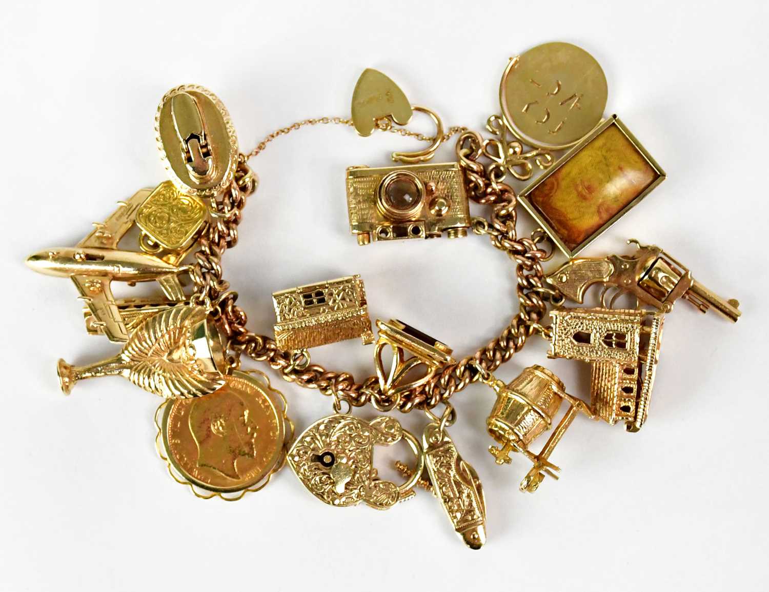 Lot 810 - A 9ct yellow gold curb link charm bracelet...