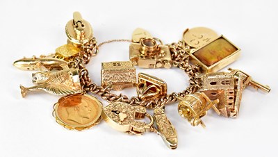 Lot 810 - A 9ct yellow gold curb link charm bracelet...