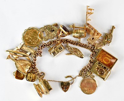 Lot 810 - A 9ct yellow gold curb link charm bracelet...