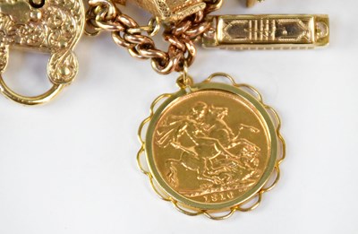 Lot 810 - A 9ct yellow gold curb link charm bracelet...