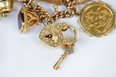 Lot 810 - A 9ct yellow gold curb link charm bracelet...