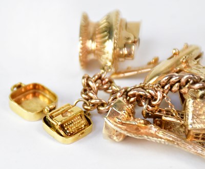 Lot 810 - A 9ct yellow gold curb link charm bracelet...
