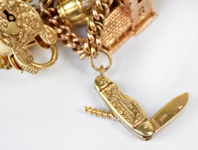 Lot 810 - A 9ct yellow gold curb link charm bracelet...