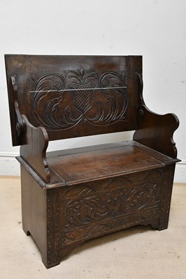Lot 2251 - An early 20th century carved oak monk's bench,...