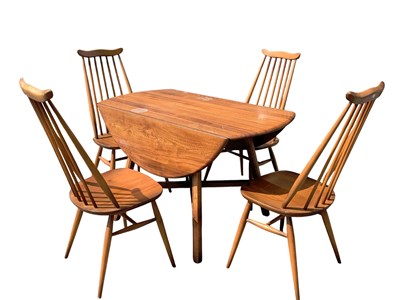 Lot 1092 - ERCOL; a drop-leaf dining table and four...