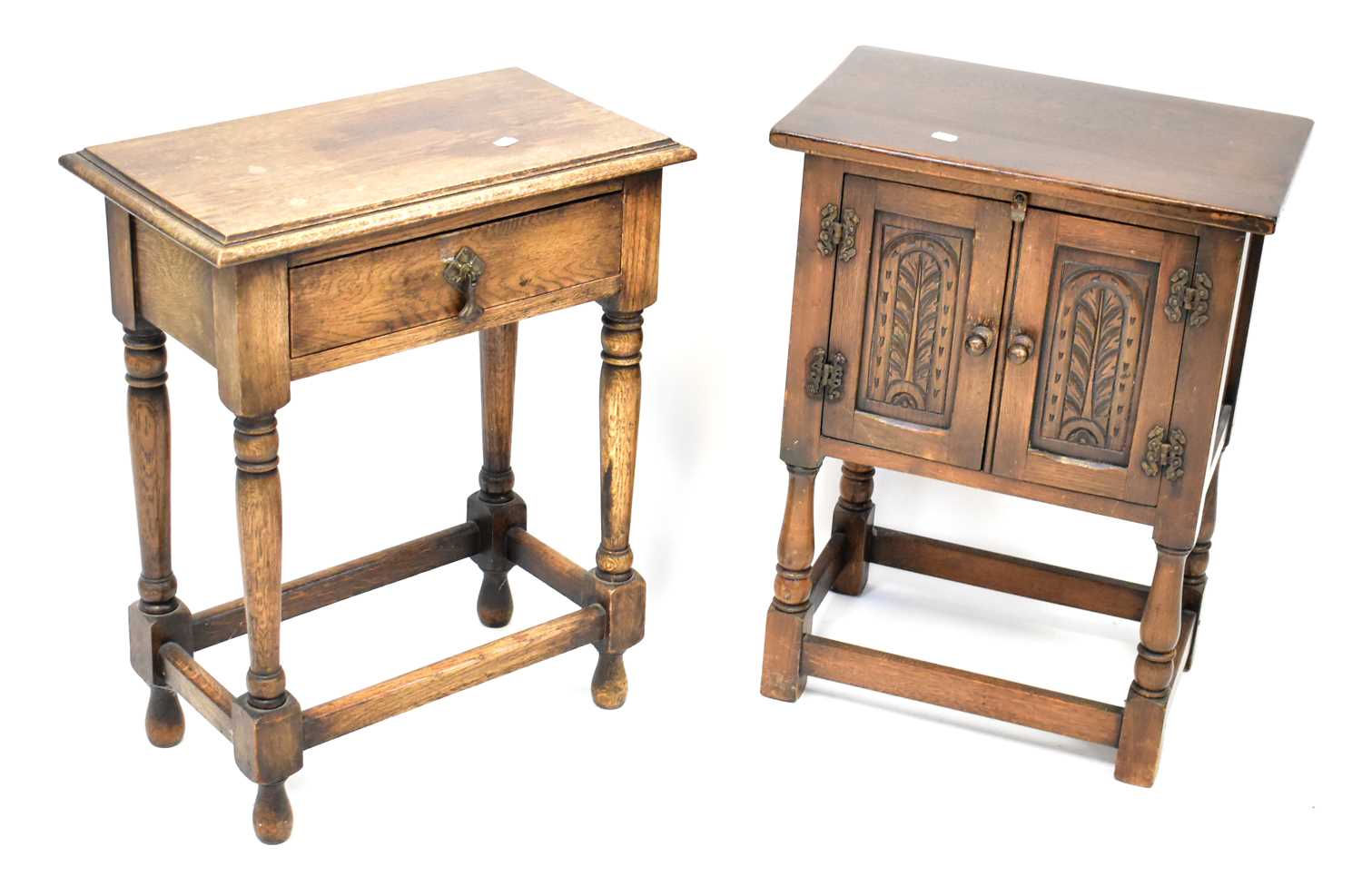 Lot 39 - A small oak two-door side cabinet, raised on...