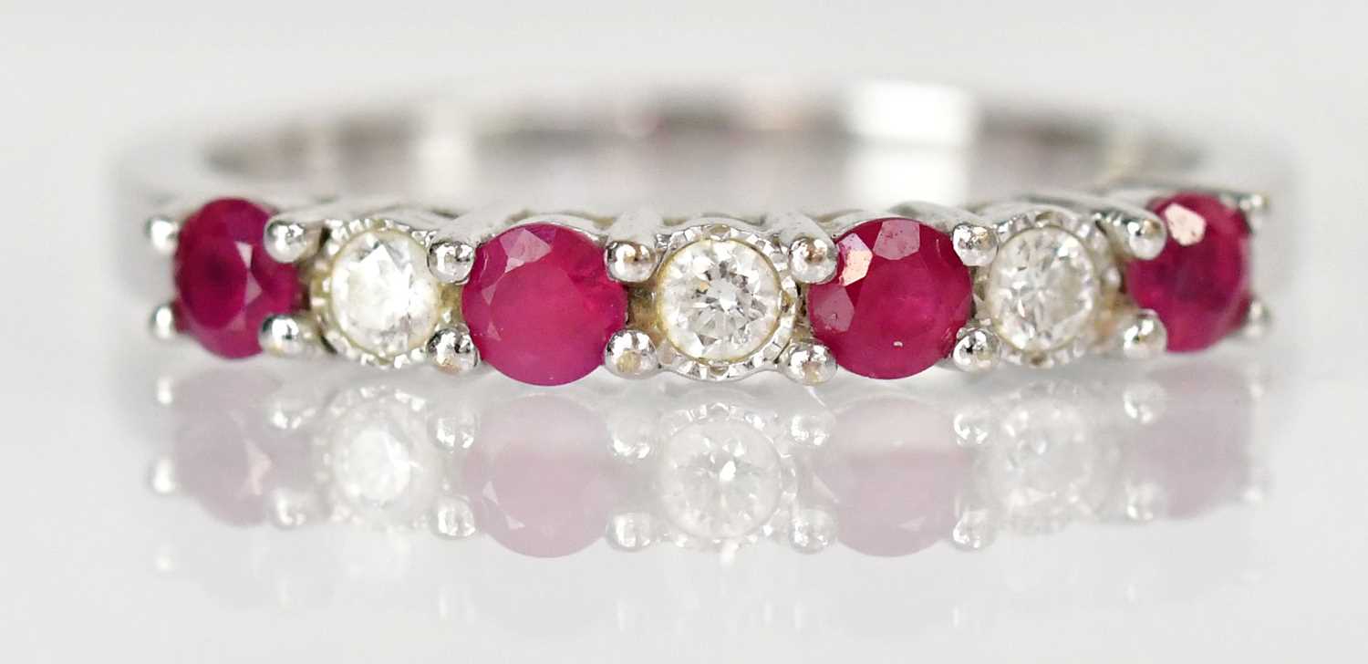 Lot 766 - An 18ct white gold ring set with four rubies...