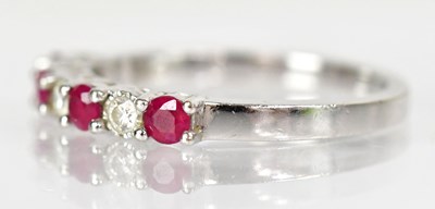 Lot 766 - An 18ct white gold ring set with four rubies...