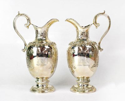 Lot 602 - GARRARD; a pair of silver wine jugs to...