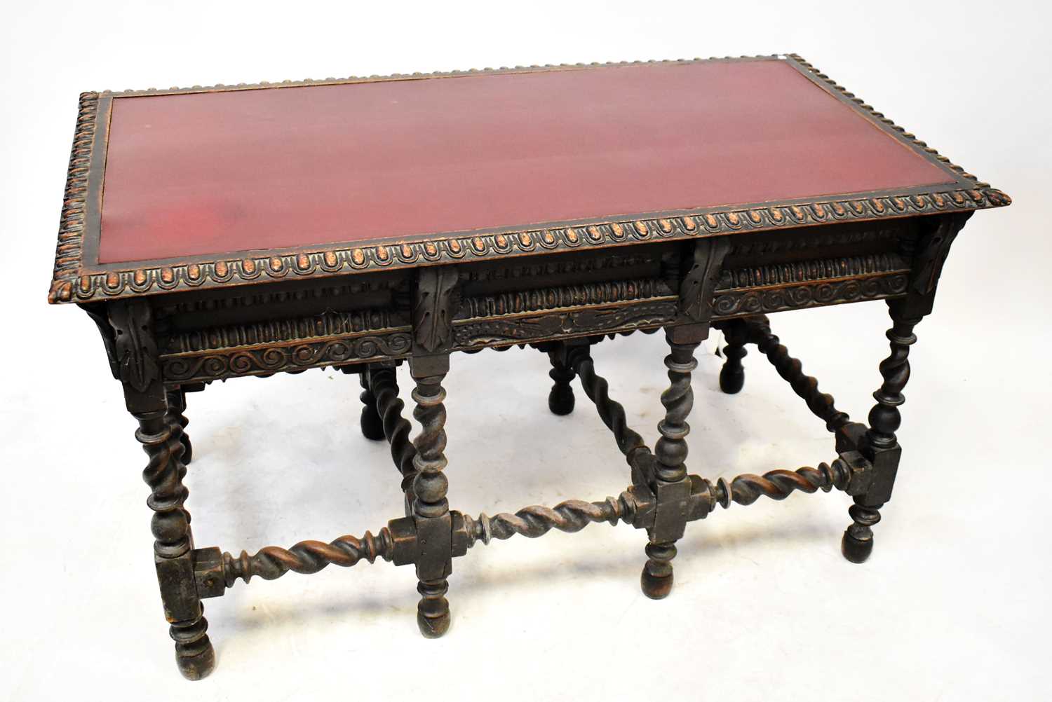 Lot 38 - A reproduction oak writing table, with oxblood...