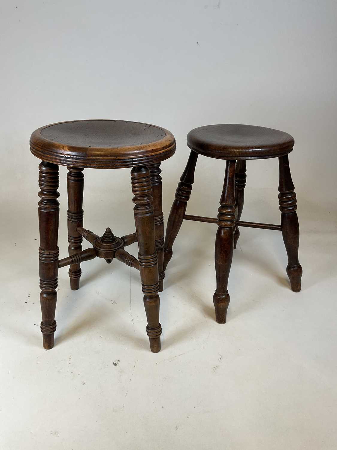 Lot 745 - An elm seated stool raised on ring turned