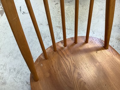 Lot 11 - ERCOL; an elm oval drop-leaf table, raised on...