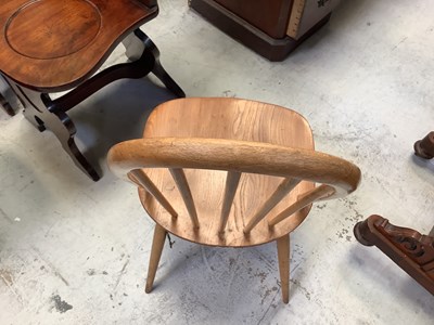 Lot 11 - ERCOL; an elm oval drop-leaf table, raised on...