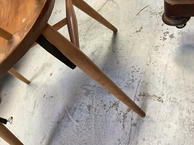 Lot 11 - ERCOL; an elm oval drop-leaf table, raised on...