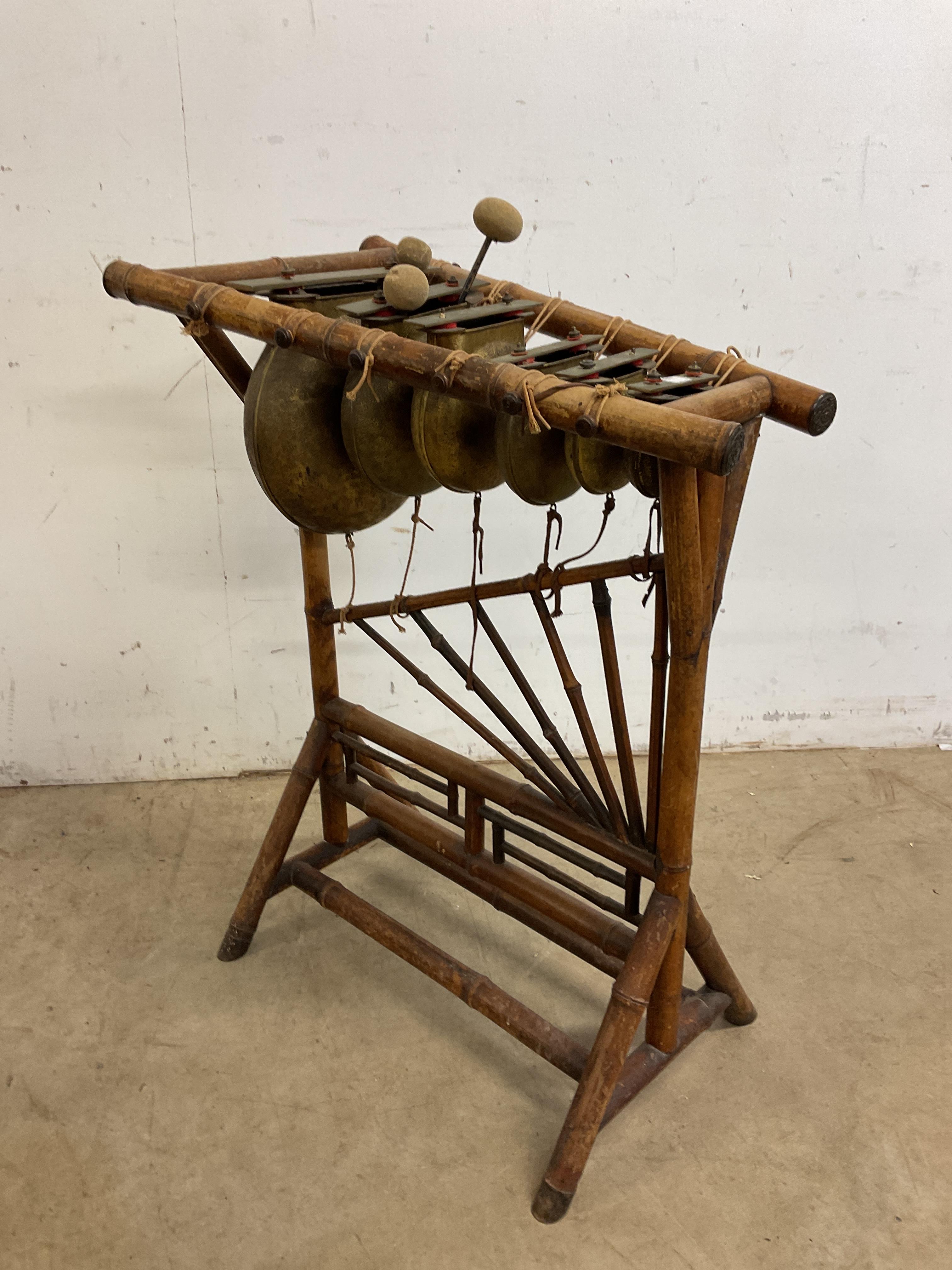 Lot 94 A bamboo framed Chinese xylophone striking on