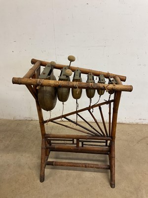 Lot 94 - A bamboo framed Chinese xylophone striking on...