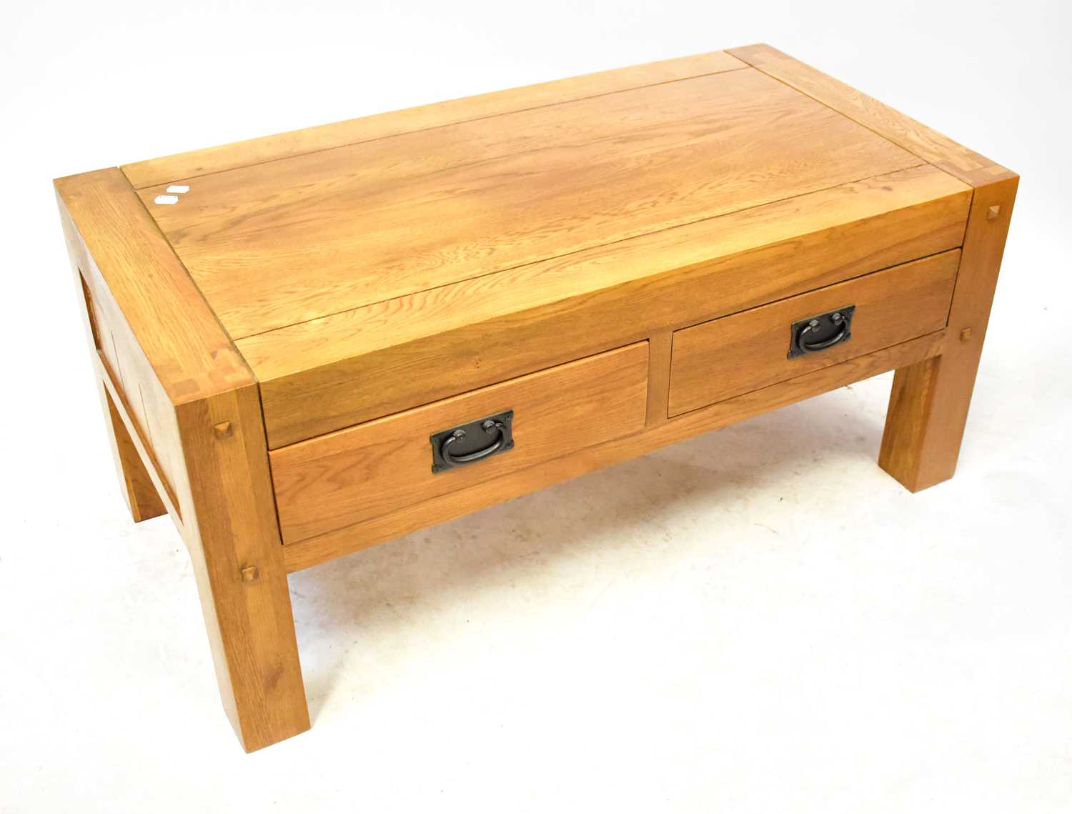 Lot 25 - An oak coffee table with a pair of drawers to...