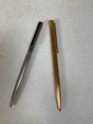 Lot 96 - DUNHILL; a silver ballpoint pen and a gold...