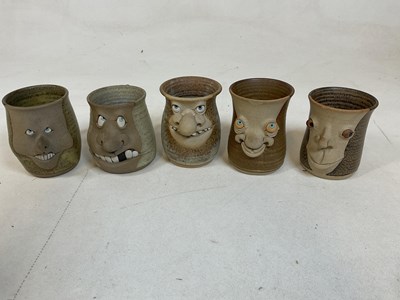 Lot 261 - A collection of "ugly mugs", 1970s pottery...