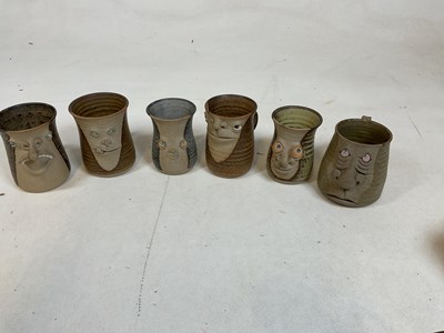 Lot 261 - A collection of "ugly mugs", 1970s pottery...