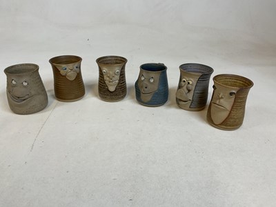Lot 261 - A collection of "ugly mugs", 1970s pottery...