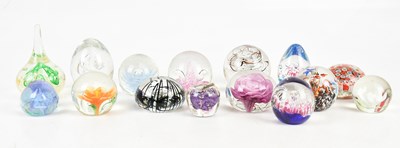 Lot 334 - A collection of fifteen glass paperweights,...
