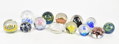 Lot 335 - A collection of thirteen glass paperweights,...