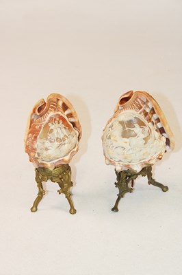 Lot 1249 - A pair of unusual carved conch shells mounted...