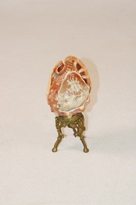 Lot 1249 - A pair of unusual carved conch shells mounted...