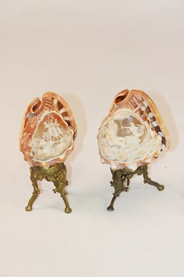Lot 1249 - A pair of unusual carved conch shells mounted...