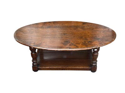 Lot 2220 - A large reproduction oak oval two tier coffee...
