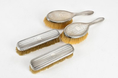 Lot 1550 - WALKER & HALL; a hallmarked silver four piece...