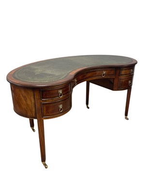 Lot 2207 - A reproduction mahogany kidney shaped desk,...