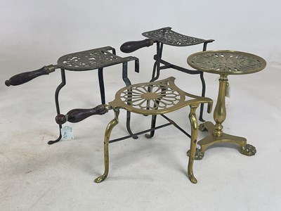 Lot 1123 - A Georgian brass tripod trivet with pierced...