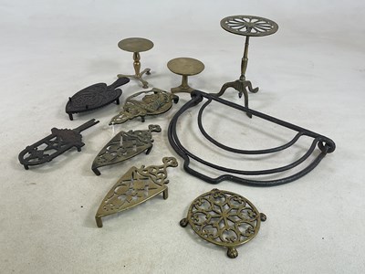 Lot 1124 - A group of small trivets and hearth ornaments,...