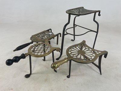 Lot 1125 - Four Georgian brass trivets, two with turned...